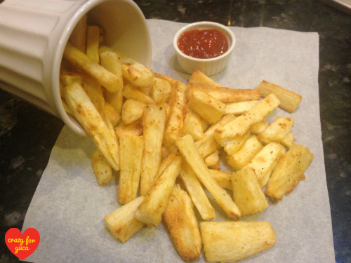 Yuca Fries tumbling out of a mug.