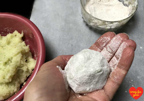 Roll each Stuffed Cassava Ball in cassava flour