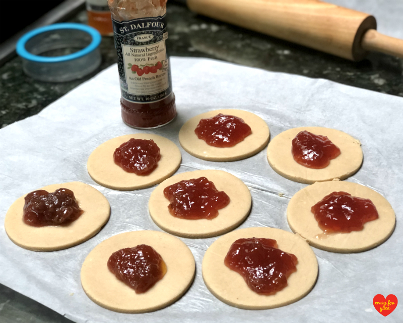 Rolled out cassava flour dough circles with St. Dalfour strawberry fruit spread in the center of each