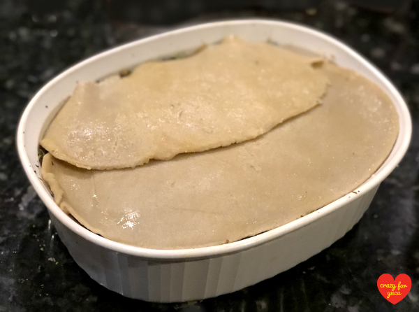 CrazyForYuca.com - a "real food" gluten and dairy-free recipe blog and place for all things yuca / cassava. A white Corningware baking dish layered with Cassava Flour Pasta Lasagna. Top pasta layer exposed.