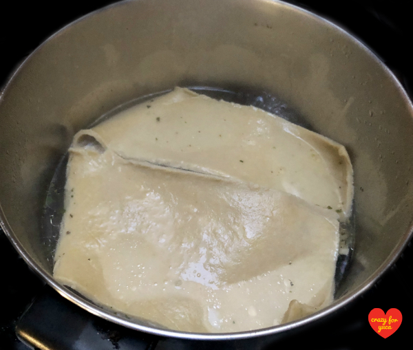 CrazyForYuca.com - a "real food" gluten and dairy-free recipe blog and place for all things yuca / cassava. Cassava Flour Pasta lasagna pieces boiling in large pot of water. 