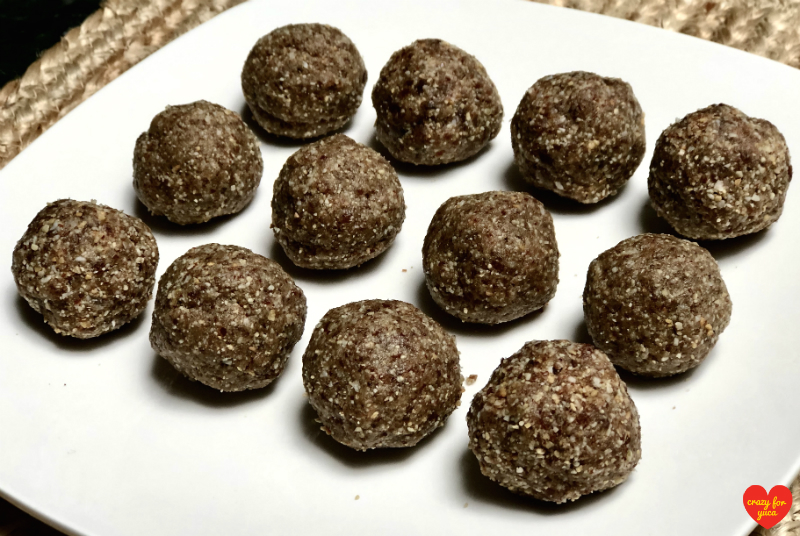 CrazyForYuca.com - 12 Paleo No-Bake Date Nut Balls on white square plate. 