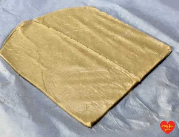 CrazyForYuca.com - a real food, gluten and dairy-free blog featuring all things yuca / cassava. A piece of rolled out Cassava Flour Pasta cut into 2 lasagna sized pieces of pasta. 