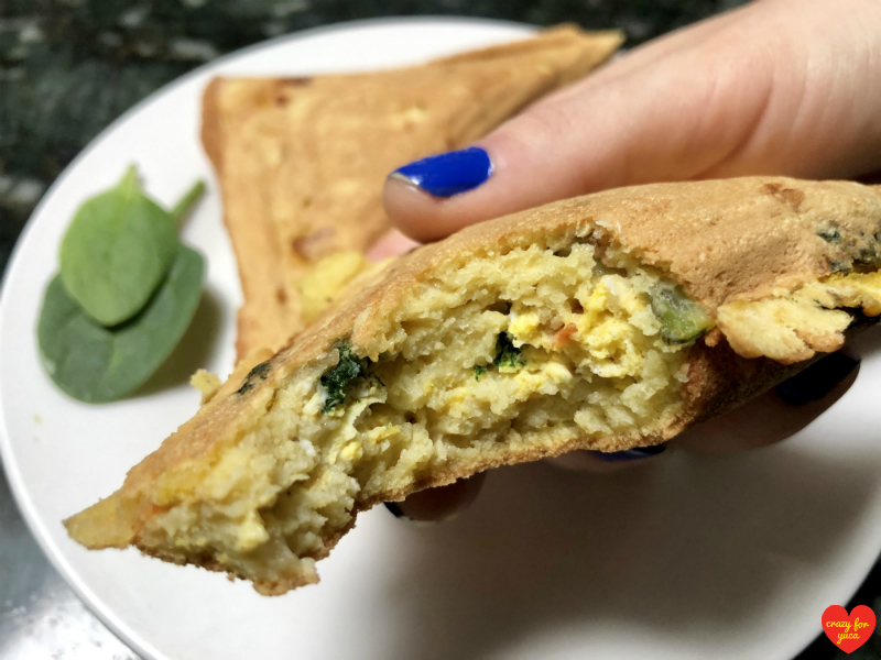 Grain-Free Pancake Pocket with a bite taken out of it showing the veggie egg filling. CrazyForYuca.com
