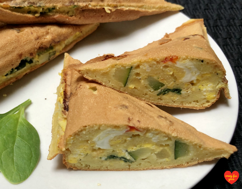 Grain-Free Pancake Pocket on white plate with one cut in half to reveal vegetable egg filling. CrazyForYuca.com